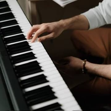 Adult hands playing piano keys